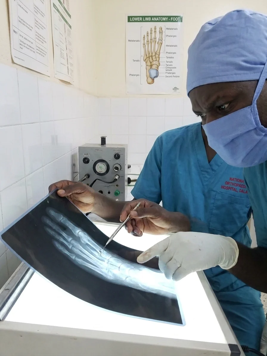 Dr. Raymond Joseph Malinga reviewing an orthopaedic X-ray